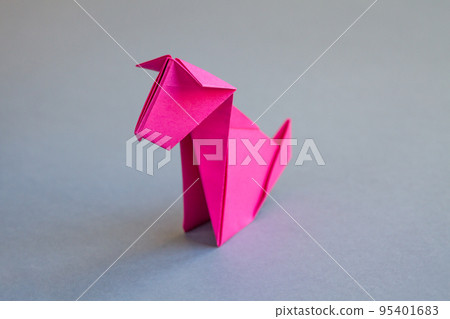 Pink paper dog origami isolated on a grey background 95401683