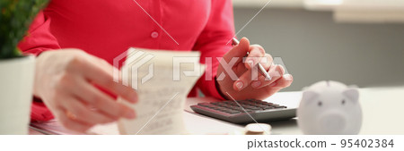 Female accountant count numbers on calculator, stacks of coins on office desk Female accountant count numbers on calculator, stacks of coins on office desk 95402384