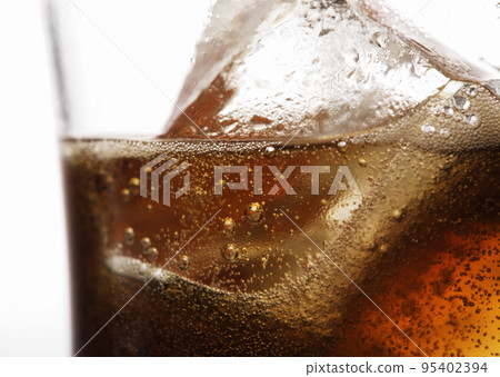 Glass of cola with ice cubes Glass of cola with ice cubes 95402394