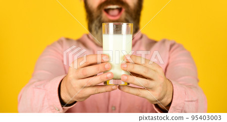 surprised man hold glass of milk. pasteurized milk. Man offer tasty vegan milk from glass. buy in supermarket. Milk Pasteurization in Dairy Processing Plant. selective focus 95403003