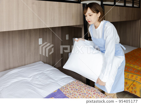 Cute woman making a bed 95405177