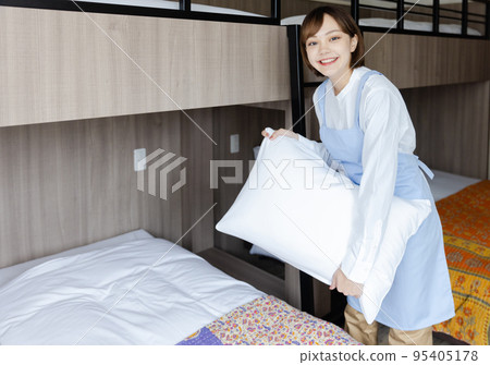 Cute woman making a bed 95405178