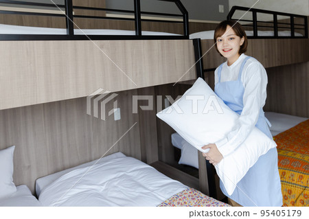 Cute woman making a bed 95405179