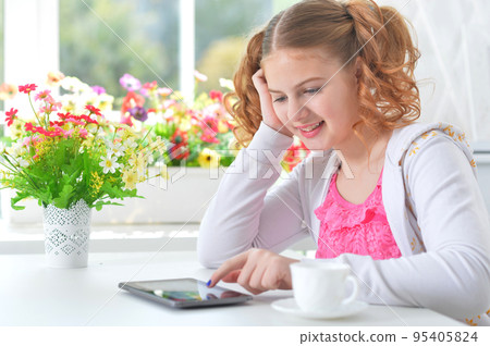 Portrait of little cute girl use tablet 95405824