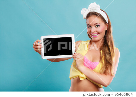 Pin up girl with tablet. Blank screen copyspace. Pin up girl with tablet. Blank screen copyspace. 95405904