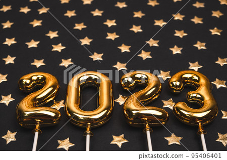 festive black background with gold numbers 2023 and gold stars. holiday greeting card. 95406401