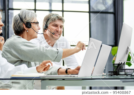 Call center agent with headset working on support hotline 95408867