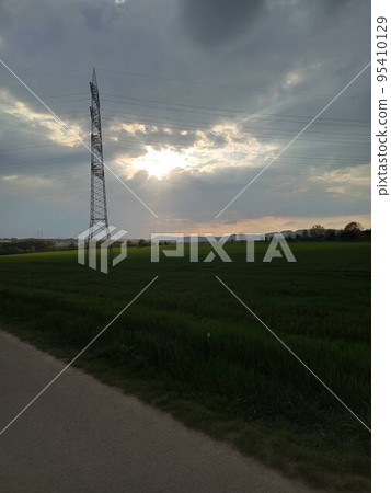 Power Transmission Towers. Air hi-voltage electric line supports at field under blue sky. Belgorod region landscape 95410129