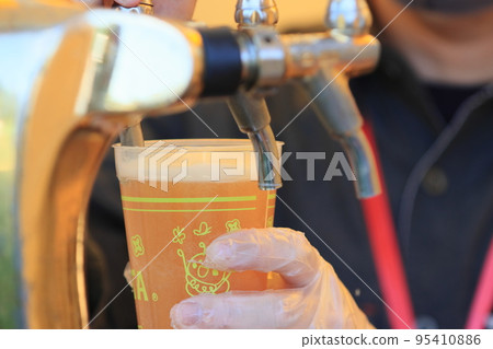 Beer poured from the tap, craft beer, draft beer 95410886