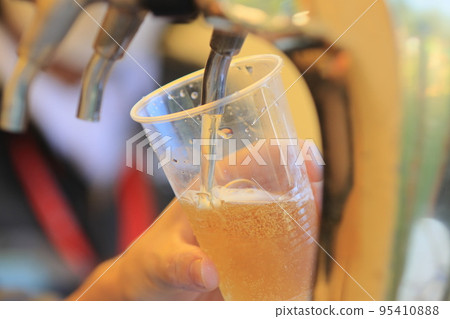 Beer poured from the tap, craft beer, draft beer 95410888