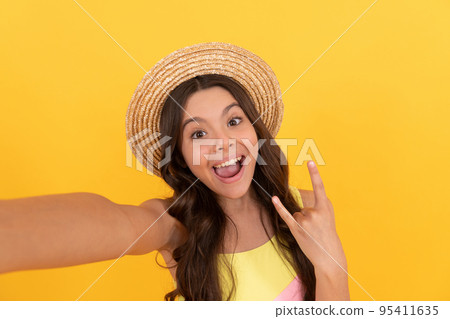oh my god. amazed teen girl with curly hair on yellow background. happy childhood. 95411635