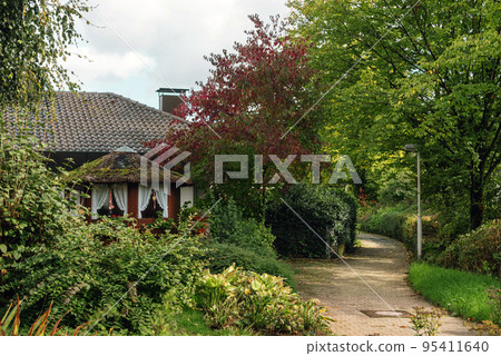 Traditional Small House With Beautiful Outdoor Decor Facade In Germany. German Old Brick Building House Ancient European City German Architect 95411640