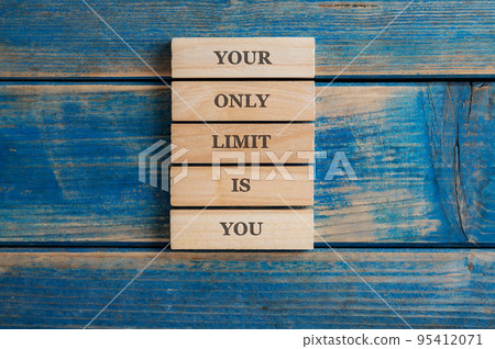 Your only limit is you sign written on a stack of five wooden pegs Your only limit is you sign written on a stack of five wooden pegs 95412071