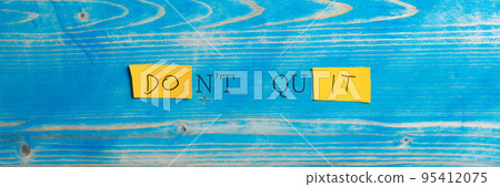 Wide view image of a Dont quit, Do it sign spelled on yellow papers Wide view image of a Dont quit, Do it sign spelled on yellow papers 95412075