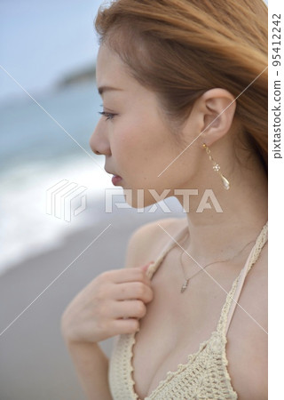 在海灘上穿著比基尼泳裝的年輕女子 95412242