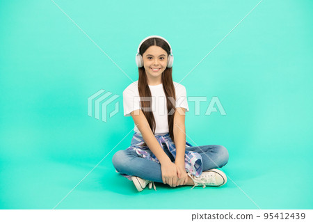 happy teen girl listen to music in wireless headphones, new technology 95412439