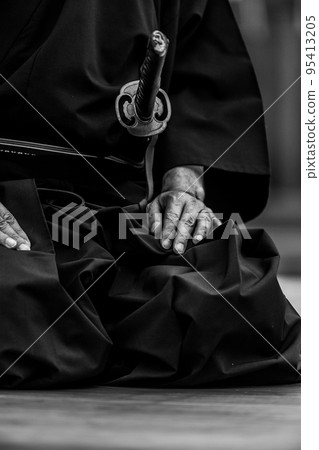 A person holding a Japanese sword A person holding a Japanese sword 95413205