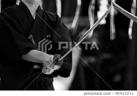 A person holding a Japanese sword A person holding a Japanese sword 95413211