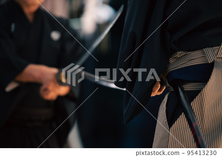 A person holding a Japanese sword A person holding a Japanese sword 95413230