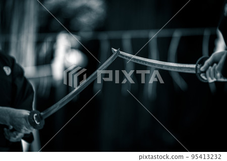 A person holding a Japanese sword A person holding a Japanese sword 95413232