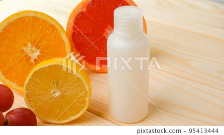Vitamins. White empty bottle for vitamins on a background of citrus fruit slices. lemon. orange. White background. Blank Medicine bottle Vitamins. White empty bottle for vitamins on a background of citrus fruit slices. lemon. orange. White background. Blank Medicine bottle 95413444