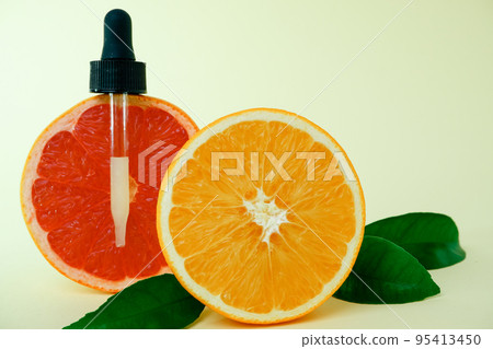 Dropper bottle filled with citrus oil. Juicy ripe citrus fruit slices. lemon. Orange. Grapefruit. Grape. Skin care. Organic, bio cosmetics healthy concept 95413450