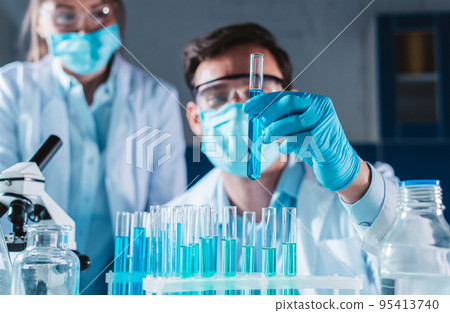 Doctor in the laboratory analyzes samples of codiv-9 under a microscope Doctor in the laboratory analyzes samples of codiv-9 under a microscope 95413740
