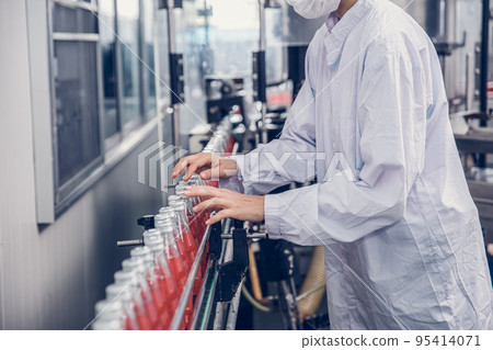 food and drink industry staff worker working at conveyor belt production line machine in beverage factory with clean and hygiene area. food and drink industry staff worker working at conveyor belt production line machine in beverage factory with clean and hygiene area. 95414071