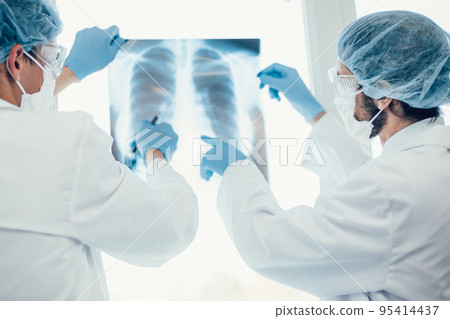 close up. medical colleagues discussing an x-ray of the lungs . 95414437