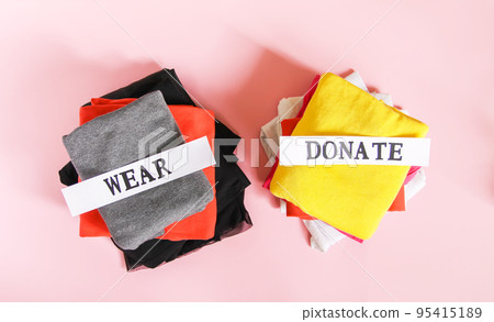 Clothes sorting in wardrobe for donation and wearing with paper notes. Clothes sorting in wardrobe for donation and wearing with paper notes. 95415189