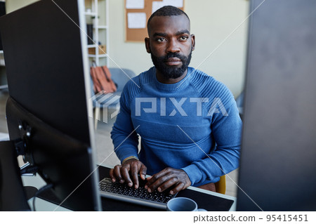 African American Man Using Computer at Home Office African American Man Using Computer at Home Office 95415451