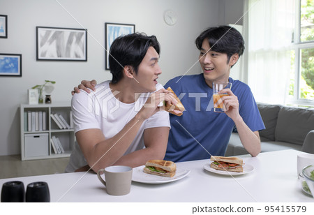 Asian male couple lifestyle living concept. Happy LGBT gay couple having breakfast together Asian male couple lifestyle living concept. Happy LGBT gay couple having breakfast together 95415579