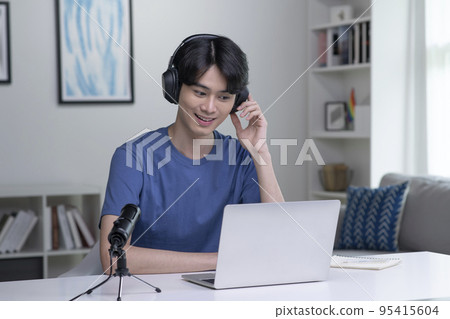 Asian businessman on video call with clients on laptop. Young Asian man giving online educational Asian businessman on video call with clients on laptop. Young Asian man giving online educational 95415604