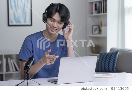 Asian businessman on video call with clients on laptop. Young Asian man giving online educational Asian businessman on video call with clients on laptop. Young Asian man giving online educational 95415605