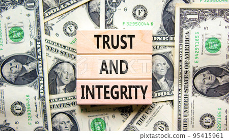 Trust and integrity symbol. Concept words Trust and integrity on wooden blocks. Dollar bills. Beautiful background from dollar bills. Business, psychological trust and integrity concept. Copy space. Trust and integrity symbol. Concept words Trust and integrity on wooden blocks. Dollar bills. Beautiful background from dollar bills. Business, psychological trust and integrity concept. Copy space. 95415961