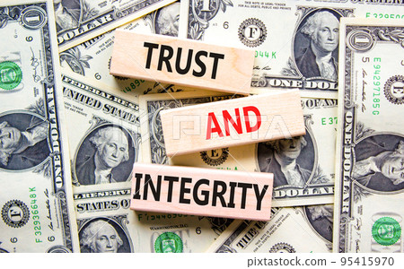 Trust and integrity symbol. Concept words Trust and integrity on wooden blocks. Dollar bills. Beautiful background from dollar bills. Business, psychological trust and integrity concept. Copy space. Trust and integrity symbol. Concept words Trust and integrity on wooden blocks. Dollar bills. Beautiful background from dollar bills. Business, psychological trust and integrity concept. Copy space. 95415970