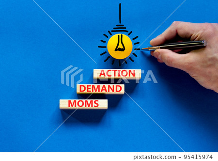 Moms demand action symbol. Concept words Moms demand action on wooden blocks on a beautiful blue table blue background. Businessman hand. Business, finacial and Moms demand action concept. Moms demand action symbol. Concept words Moms demand action on wooden blocks on a beautiful blue table blue background. Businessman hand. Business, finacial and Moms demand action concept. 95415974