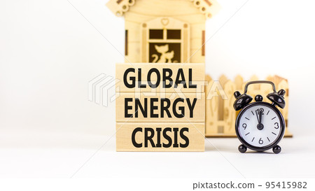Global energy crisis symbol. Concept words Global energy crisis on wooden blocks. Black alarm clock. Beautiful white table white background. Business and global energy crisis concept. Copy space. Global energy crisis symbol. Concept words Global energy crisis on wooden blocks. Black alarm clock. Beautiful white table white background. Business and global energy crisis concept. Copy space. 95415982