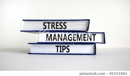 Stress management tips symbol. Books with words 'Stress management tips'. Beautiful white background. Psychological, business and stress management tips concept. Copy space. Stress management tips symbol. Books with words 'Stress management tips'. Beautiful white background. Psychological, business and stress management tips concept. Copy space. 95415984