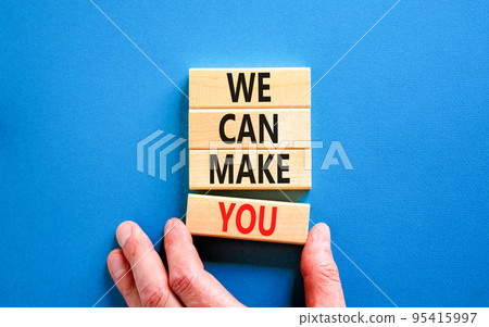 Support and we can make you symbol. Concept words We can make you on wooden blocks. Beautiful blue table blue background. Businessman hand. Business psychological we can make you concept. Copy space 95415997