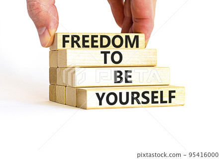Freedom to be yourself symbol. Concept words Freedom to be yourself on wooden blocks on a beautiful white background. Businessman hand. Business, psychological freedom to be yourself concept. Freedom to be yourself symbol. Concept words Freedom to be yourself on wooden blocks on a beautiful white background. Businessman hand. Business, psychological freedom to be yourself concept. 95416000
