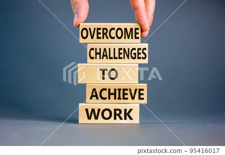 Overcome challenges to achieve goals symbol. Concept words Overcome challenges to achieve goals on wooden blocks on a beautiful grey background. Businessman hand. Business goals concept. Copy space. Overcome challenges to achieve goals symbol. Concept words Overcome challenges to achieve goals on wooden blocks on a beautiful grey background. Businessman hand. Business goals concept. Copy space. 95416017