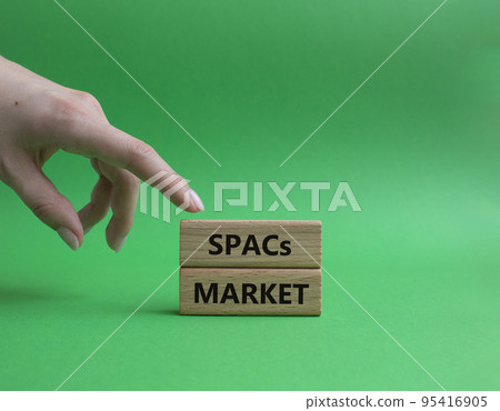SPACs market symbol. Concept words SPACs market - special purpose acquisition companies market - on wooden blocks. Beautiful green background. Businessman hand. Business concept. Copy space. SPACs market symbol. Concept words SPACs market - special purpose acquisition companies market - on wooden blocks. Beautiful green background. Businessman hand. Business concept. Copy space. 95416905