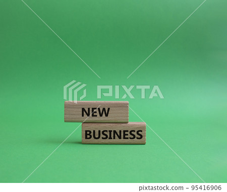 New business symbol. Concept words New business on wooden blocks. Beautiful green background. Business and New business concept. Copy space. 95416906