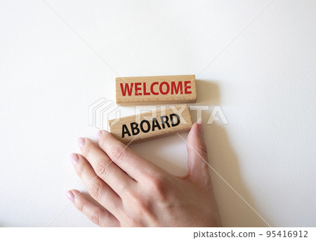 Welcome aboard symbol. Concept word Welcome aboard on wooden blocks. Beautiful white background. Businessman hand. Business and Welcome aboard concept. Copy space Welcome aboard symbol. Concept word Welcome aboard on wooden blocks. Beautiful white background. Businessman hand. Business and Welcome aboard concept. Copy space 95416912