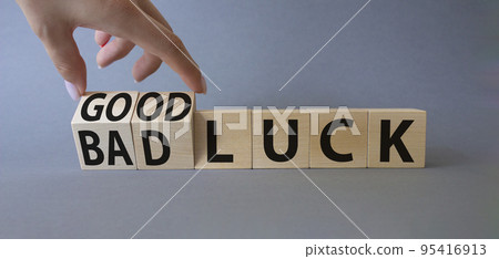 Good Luck and bad Luck symbol. Hand turns a cube and changes the words Bad Luck to Good Luck. Beautiful grey background. Businessman hand. Business concept. Copy space Good Luck and bad Luck symbol. Hand turns a cube and changes the words Bad Luck to Good Luck. Beautiful grey background. Businessman hand. Business concept. Copy space 95416913