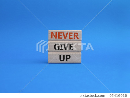 Never give up symbol. Concept words Never give up on wooden blocks. Beautiful blue background. Business and Never give up concept. Copy space. Never give up symbol. Concept words Never give up on wooden blocks. Beautiful blue background. Business and Never give up concept. Copy space. 95416916