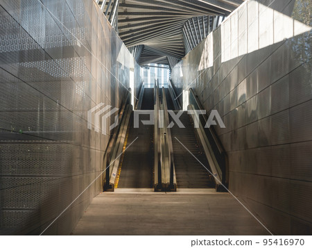 Abandoned travolator or moving walkway. Economy of electricity and other energy resources. Metal interior of flat escalator. Closed street transport for pedestrians. 95416970