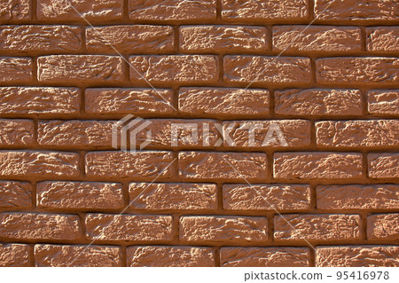 brown painted brick wall, retro style rough stone decorative facade texture close up view. 95416978