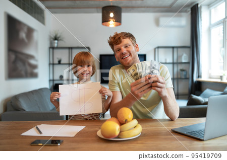 Ginger man and his son spending time together and having fun Ginger man and his son spending time together and having fun 95419709